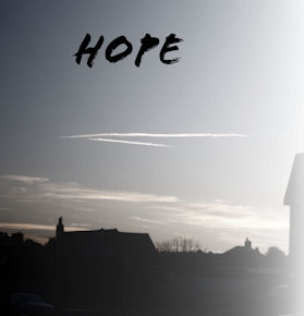 a photo of the sky, above some rooftops and the word hope
