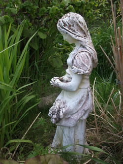 a photo of a statue of a woman in prayer